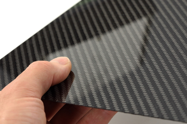 CF-carbon-fibre-sheet-in-hand-reflection